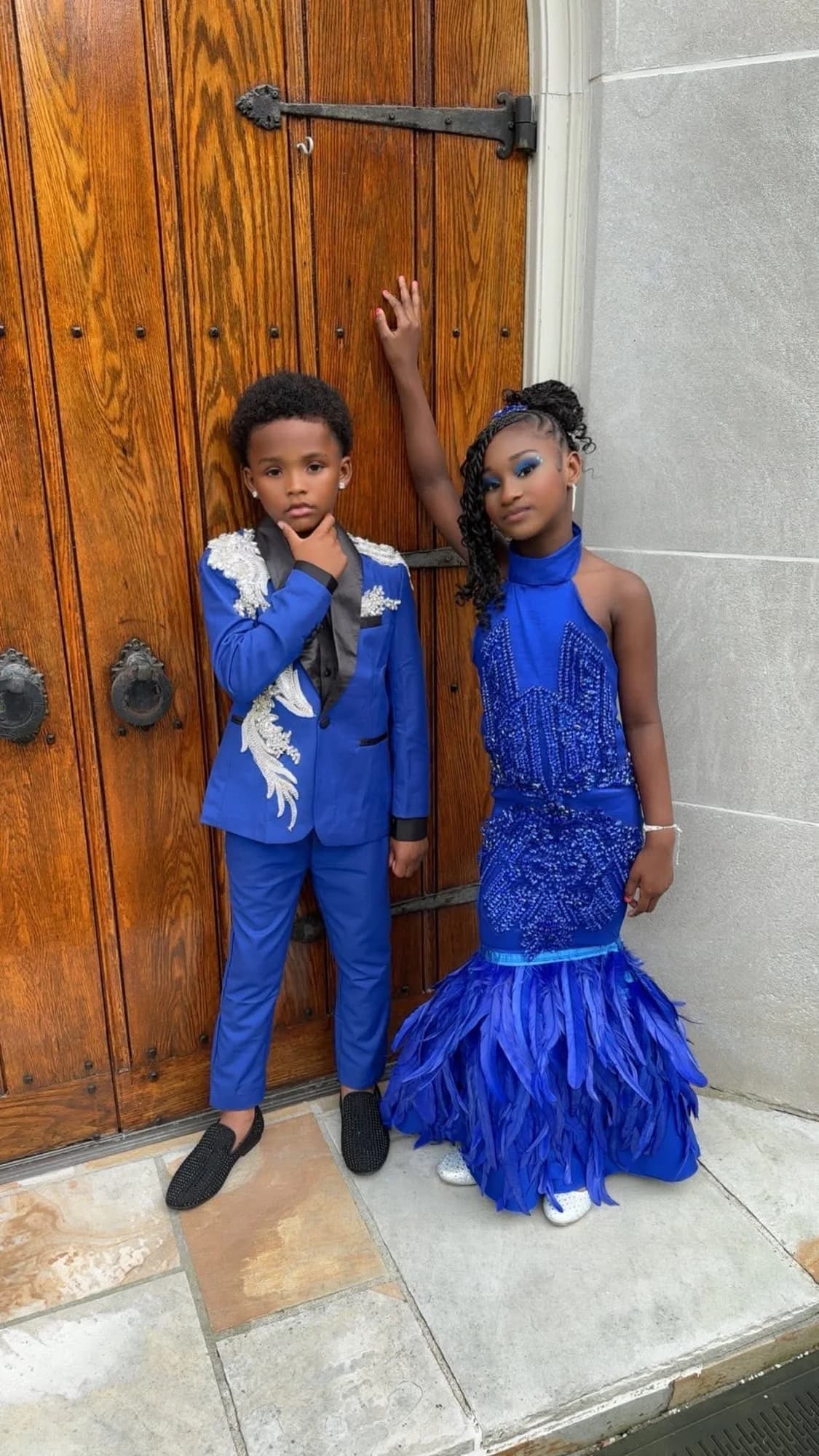 Two young clients wearing coordinated royal blue formalwear