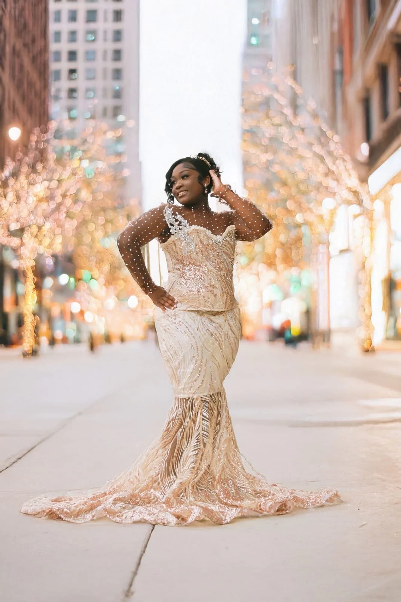 Client wearing a champagne crystal gown on a softly lit city street