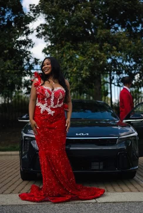 Client wearing a red gown with a silver embellished bodice