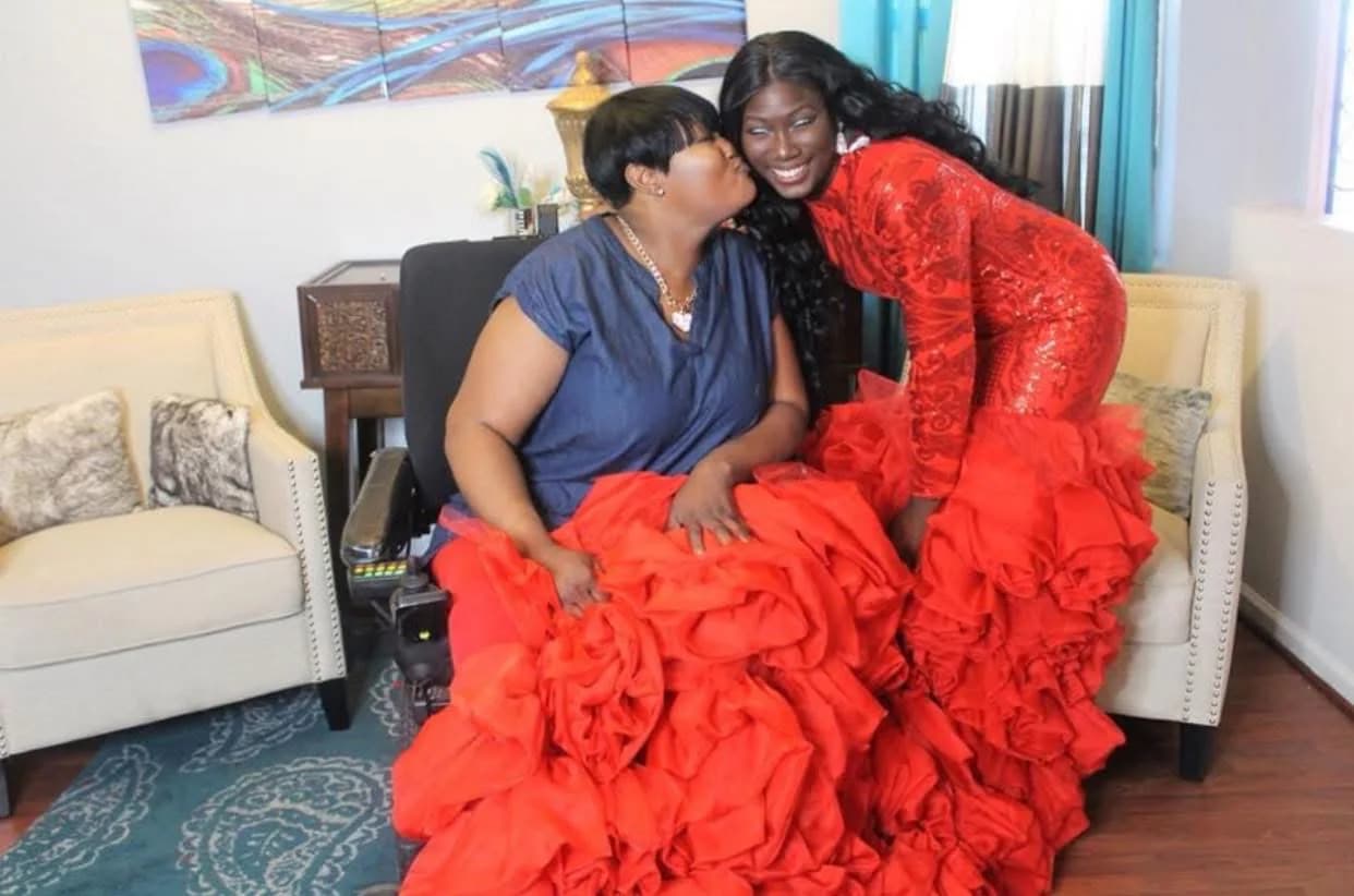 Jarrah in a red gown sharing a moment with her mother dressed in blue